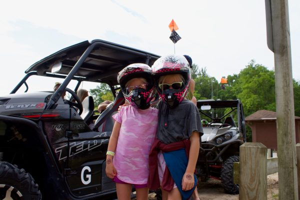 a little girl riding on the back of a truck